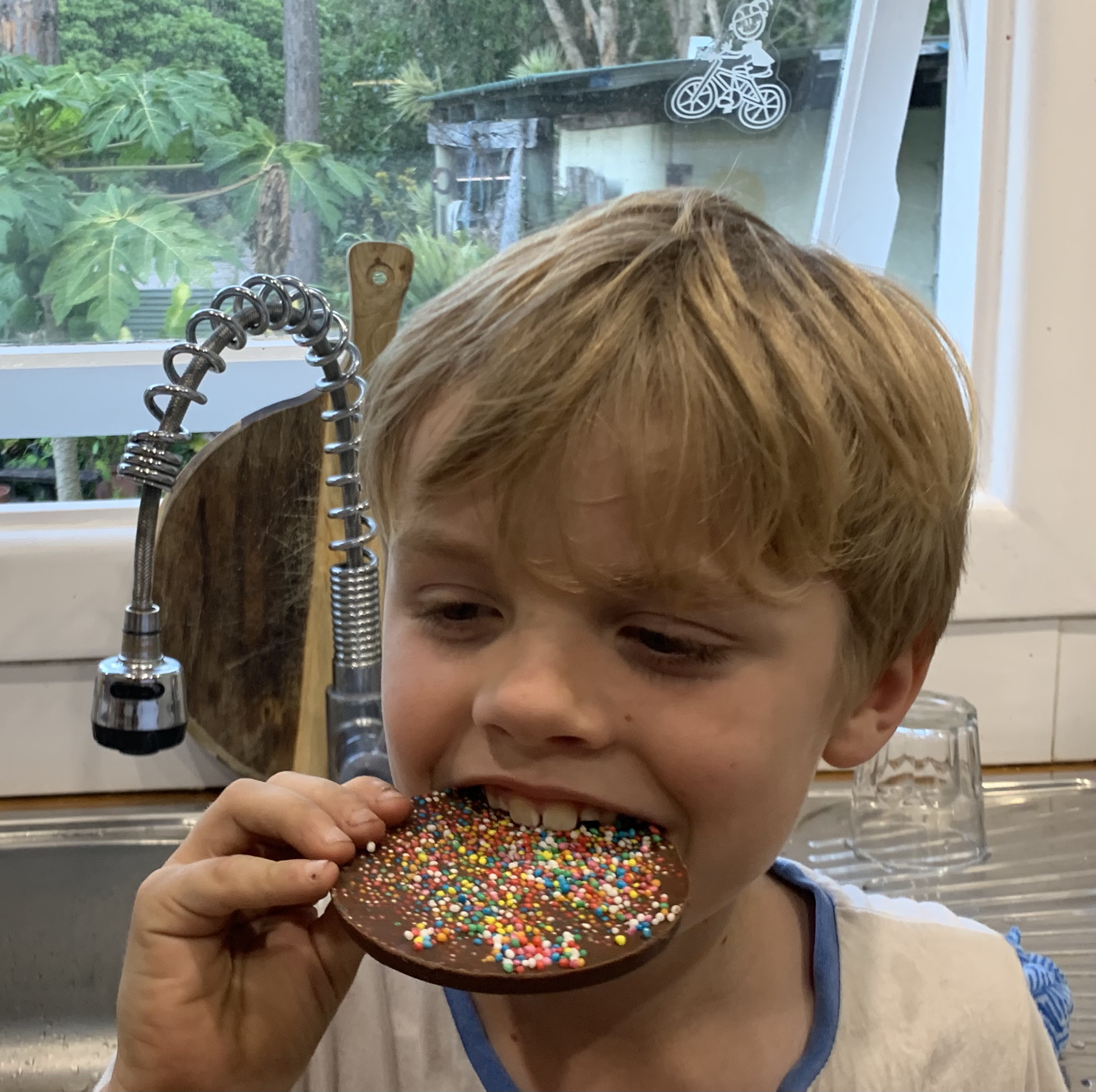 boy eating chocolate freckle